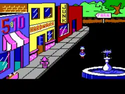 Pixel art screenshot from Donald Duck's Playground, showing Donald Duck standing near a fountain on a street with shops.