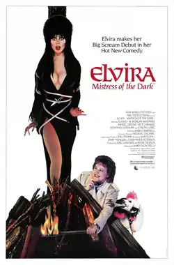 A woman dressed in black is tied up and about to be burned at the stake