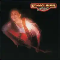 out-of-focus high-angle photo of Emmylou Harris on stage playing guitar with closed eyes and ecstatic look