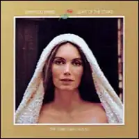 framed head and shoulders image of Emmylou Harris with white head covering looking at camera with title text and seasonal Christmas art