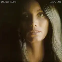 headshot photo of Emmylou Harris in shadows without expression