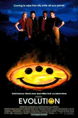 Four people standing behind a fiery yellow smiley face with three eyes