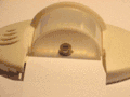 PIR motion detector housing with cylindrical faceted window. The animation highlights individual facets, each of which is a Fresnel lens, focusing light on the pyroelectric sensor element underneath.