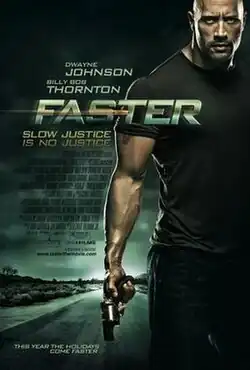 A buff man holding a pistol stands in the middle of the a road.