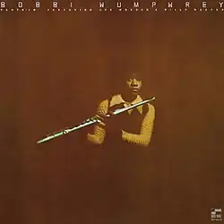 A photo of the artist holding her flute.