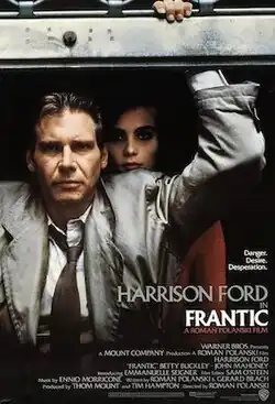 Movie poster with Harrison Ford leaning heavily from a metal door with a serious expression, while Emmanuelle Seigner stands in the shadows behind him