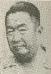 An older Chinese man looking at the camera