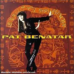 cut-out black and white photo of Pat Benatar swinging arms to side in front of orange cartoon drawings