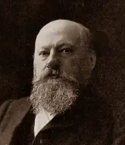 elderly, stout, bald white man with huge beard and moustache