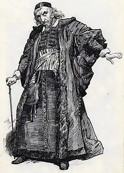 white man with pointed beard, dramatic eyebrows, long hair and beaky nose in elaborate medieval Jewish costume holding a cane