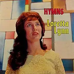 album cover photo of Loretta Lynn in yellow with multicolored background