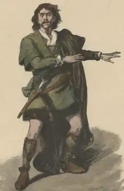 White man in Scottish medieval costume, with long hair and dagger, gesticulating