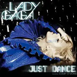 Lady Gaga lying down wearing a dark blue dress with a big, layered collar. Her right hand touches her forehead. Beneath her left eye is a blue-colored lightning-shaped sticker.