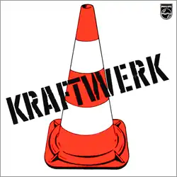 The word "Kraftwerk" superimposed over an image of a street cone with orange and white stripes.