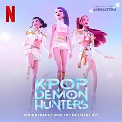 The K-Pop group, Huntrix (from left to right: Zoey, Rumi, and Mira), holding hands while standing in the air.