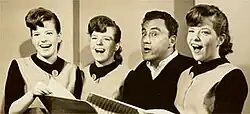 The Kane Triplets with Bill Dana in a promotional photograph for The Ed Sullivan Show (1963)