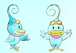 The artwork features two images of a blue bird-like animal named Kururin, one viewed from the side, and one viewed from the front. He has a yellow beak and feet, a red handkerchief around his neck, rounded goggles on top of his head, and a thin swirl for hair.