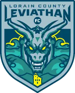 A navy blue on steel blue shield depicting a leviathan rising from the waters of Lake Erie overlooking the Lorain Lighthouse.
