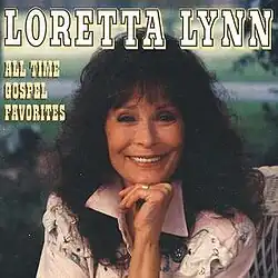 smiling photo of Loretta Lynn in western shirt
