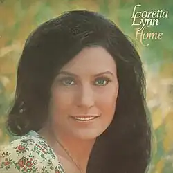headshot photo of Loretta Lynn with green yellow background