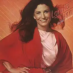 half-length photo of Loretta Lynn in red