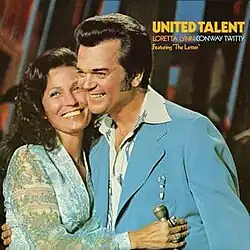 photo of Loretta Lynn and Conway Twitty on stage smiling