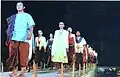 A Traditional Fashion Runway of Cambodia, joined by several models in the costume worn during Lovek period. In the photo, the lady at the left behind the man, is wearing the earliest form of av pak with Chang Kben.