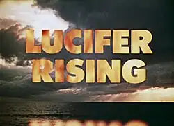 Film title card with "LUCIFER RISING" in large fiery letters against a cloudy sky