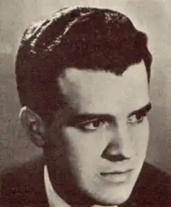 Sepia 1940s-style publicity shot of a dark-eyed, clean-shaven young man with wavy oiled hair brushed back.