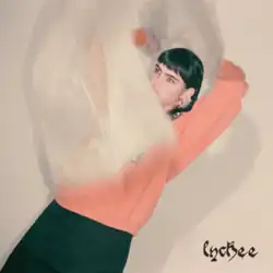 An image featuring a person wearing an orange top, partially covered by a large, translucent plastic material. The album title "lychee" is in a decorative font at the lower right.