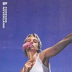 MØ holding a pink flower against a purple sky background