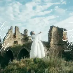 A photo of Milet standing in abandoned ruins