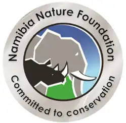 Circle with profiles of an elephant and an rhinoceros