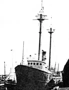 Port bow quarter photograph of Lightship 114 at a dock c. 1990