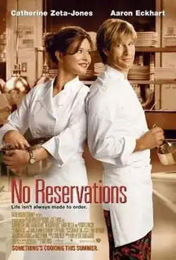 Two chefs stand back to back, a brown-haired woman holding a large metal bowl, and a blonde man stirring a small saucepan