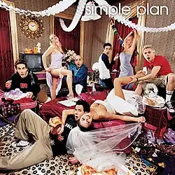 The band members partying in a hotel room with several women