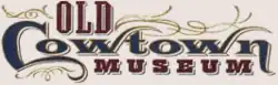 Elaborate lettering in blue, maroon, and gold