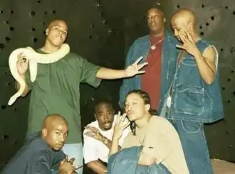 The group in 1996. Standing: Napoleon, E.D.I. Mean, and Hussein Fatal; Below: Kastro, Makaveli and Yaki Kadafi