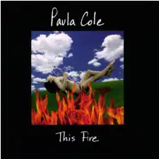 Cole on a swing set with fire around her