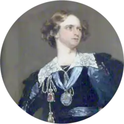 Clean-shaven white man in Renaissance-era costume with wavy hair looking intently to his left
