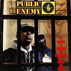 Chuck D and Flavor Flav standing behind a set of bars. The group's logo and album title can be seen as well.