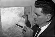A man holding a pen and pointing at a map