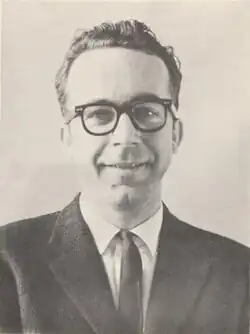 Headshot of Carney in a suit