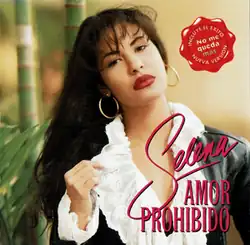 The singer is seen holding and compressing a small portion of her white shirt outwards while posing.