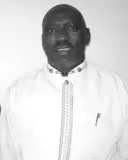 Black and white headshot of Bikindi in white clothes against a white background