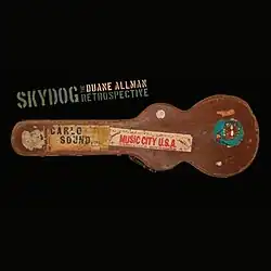 A well-worn guitar case with several stickers on it