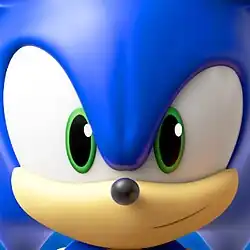 Sonic the Hedgehog runs to the left whilst looking at the player in front of a blurred background.