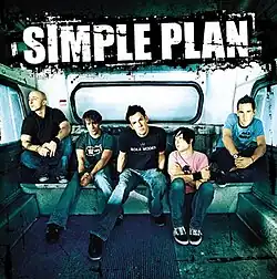 All of the band's members sitting inside a vehicle with the band's name written above in white