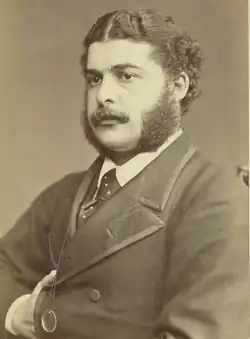 young white man with dark moustache and substantial side-whiskers