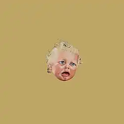 an unhappy baby's face in the middle of a plain brown background